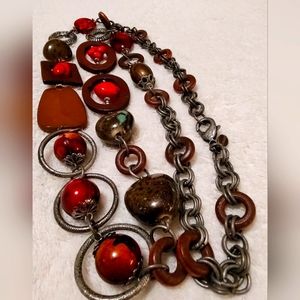 CHICO'S necklace with various red shade shapes. Excellent pre-own condition.